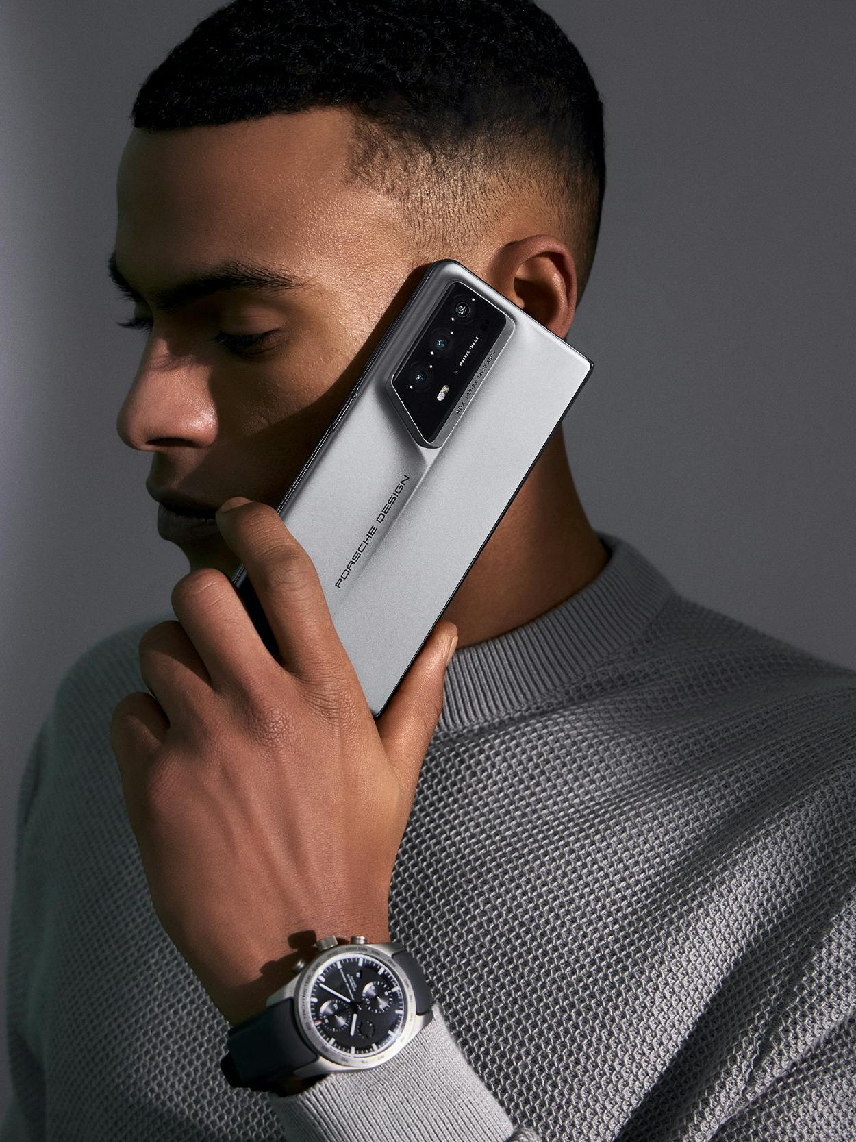 Man holding the new Porsche Design Honor Magic6 RSR Smartphone to his ear.