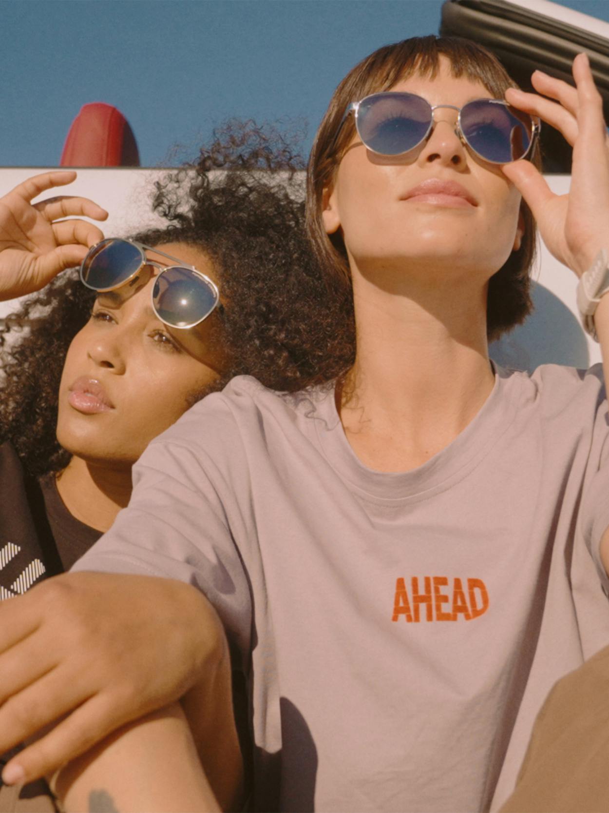 Close up of two women wearing Porsche Design sunglasses