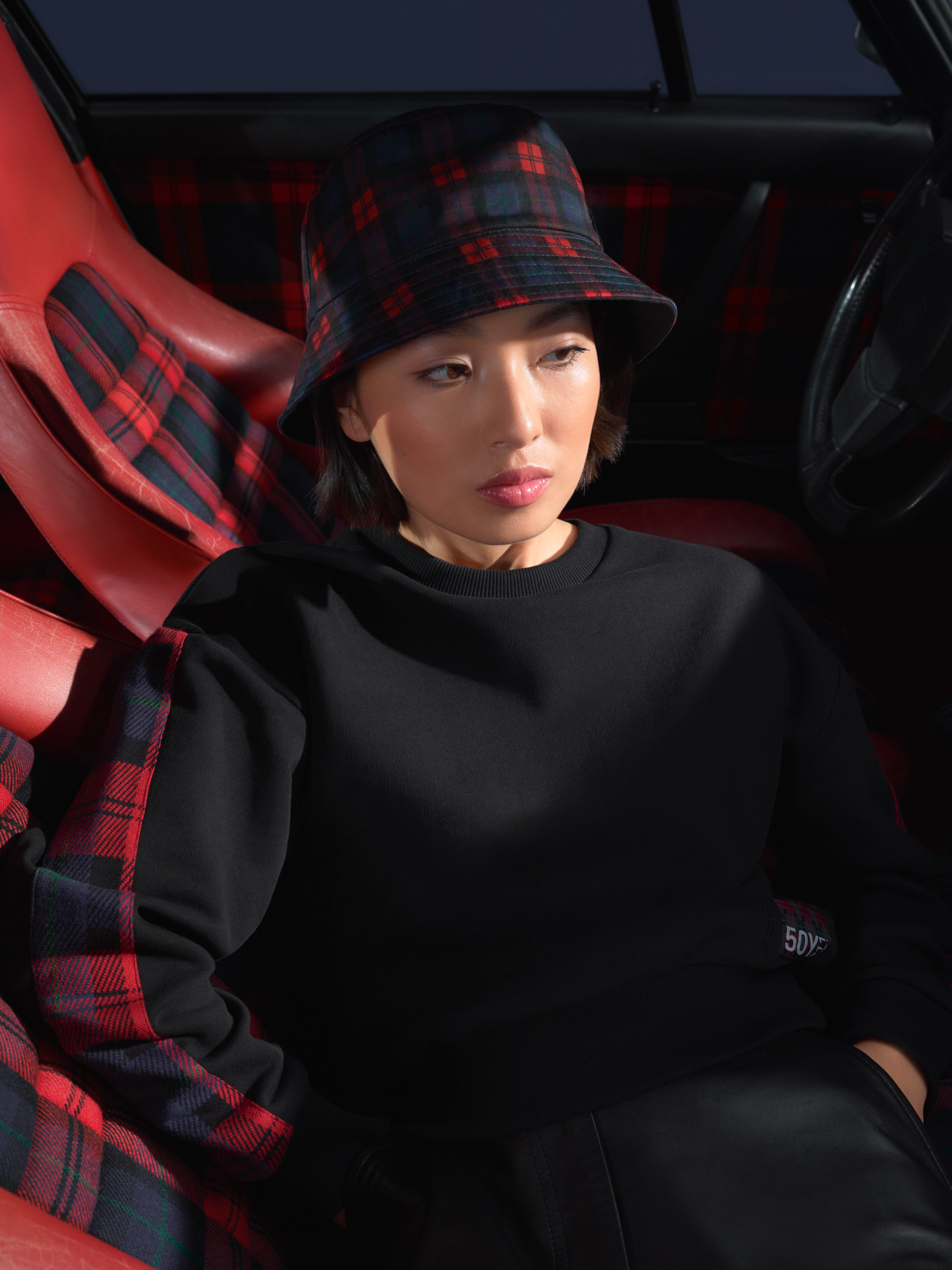 Woman is wearing clothing from the new Porsche Turbo No. 1 Collection