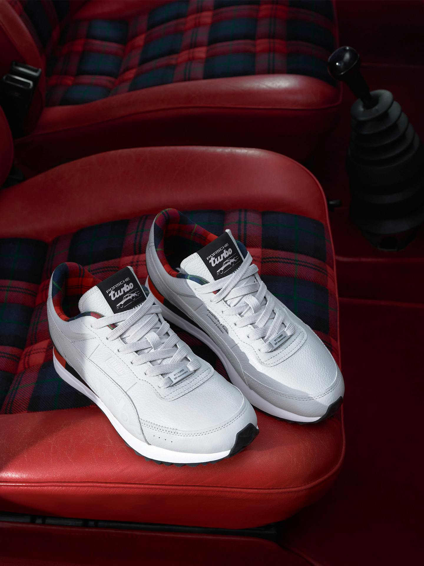 One pair of sneakers on a chair in a Porsche 911 Turbo