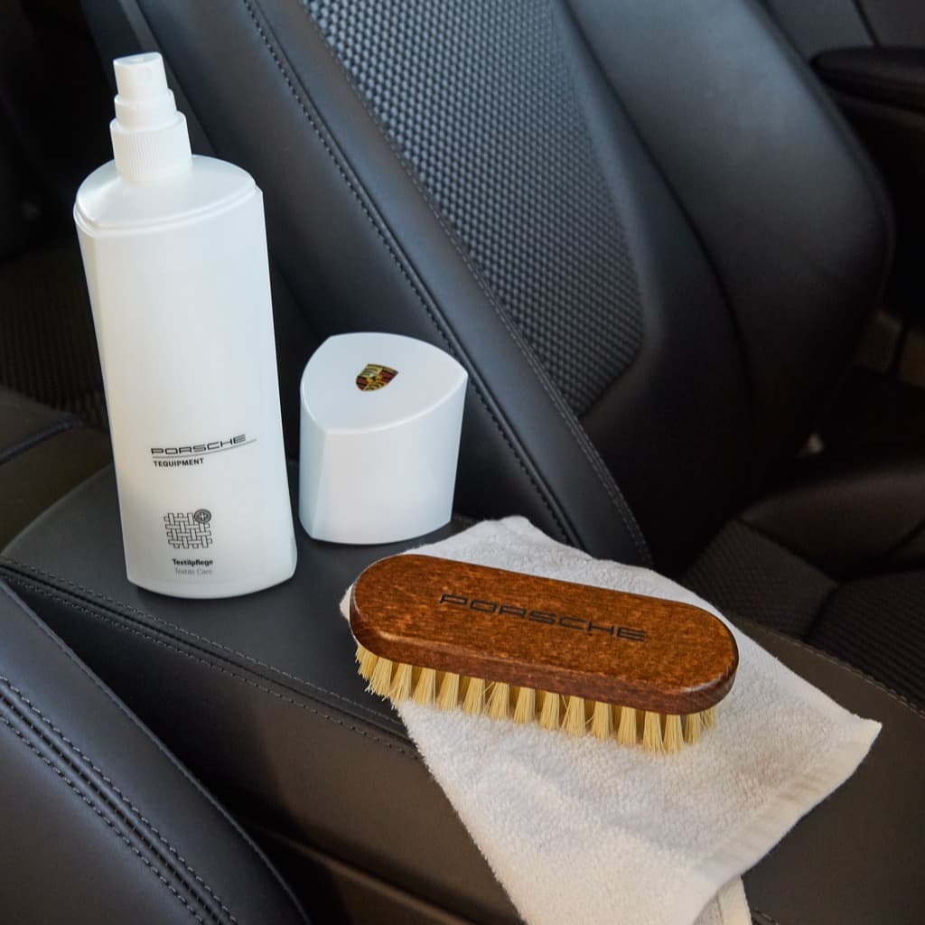You can see Porsche care product and a brush in the car