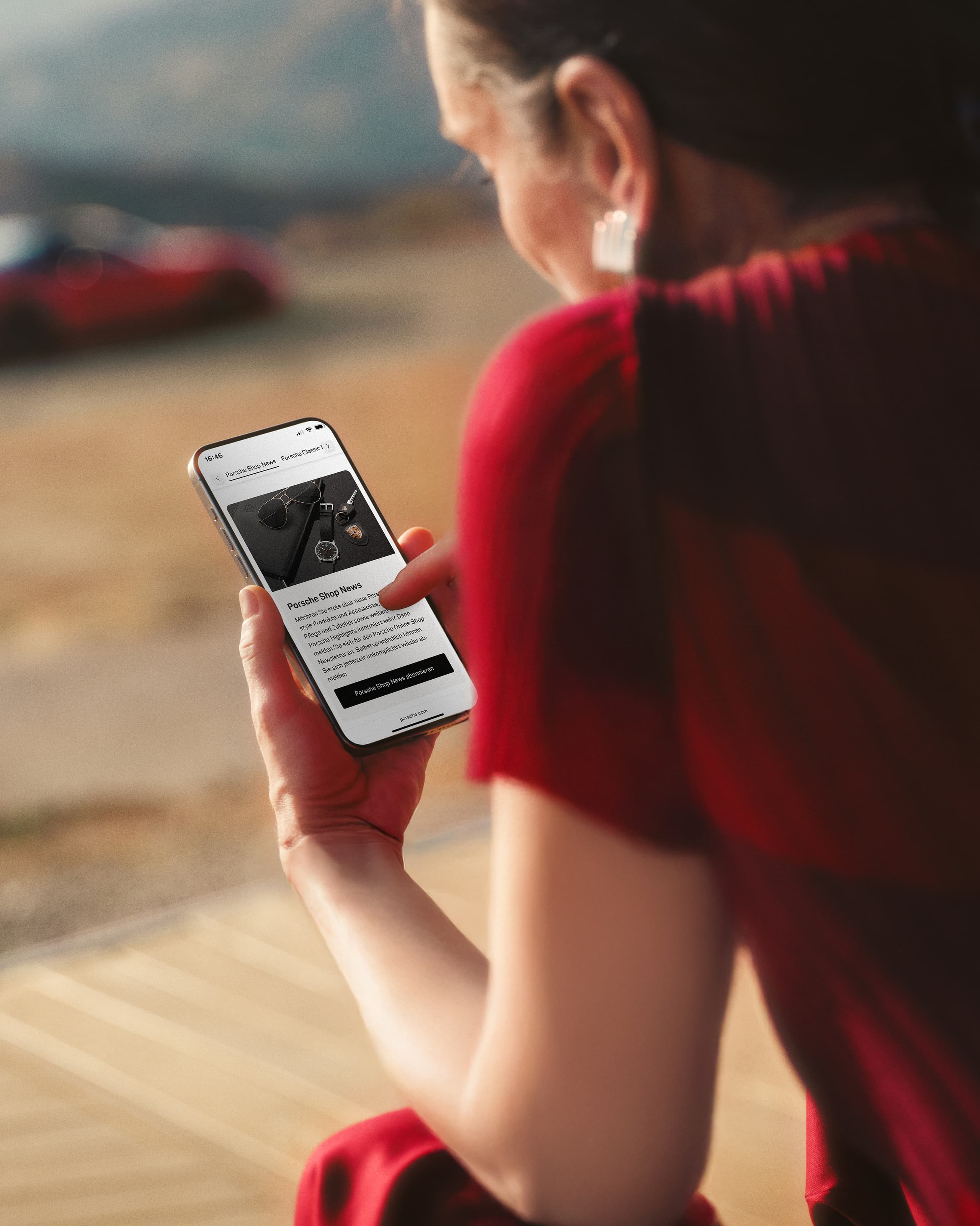 A woman from the back looking at their smartphone