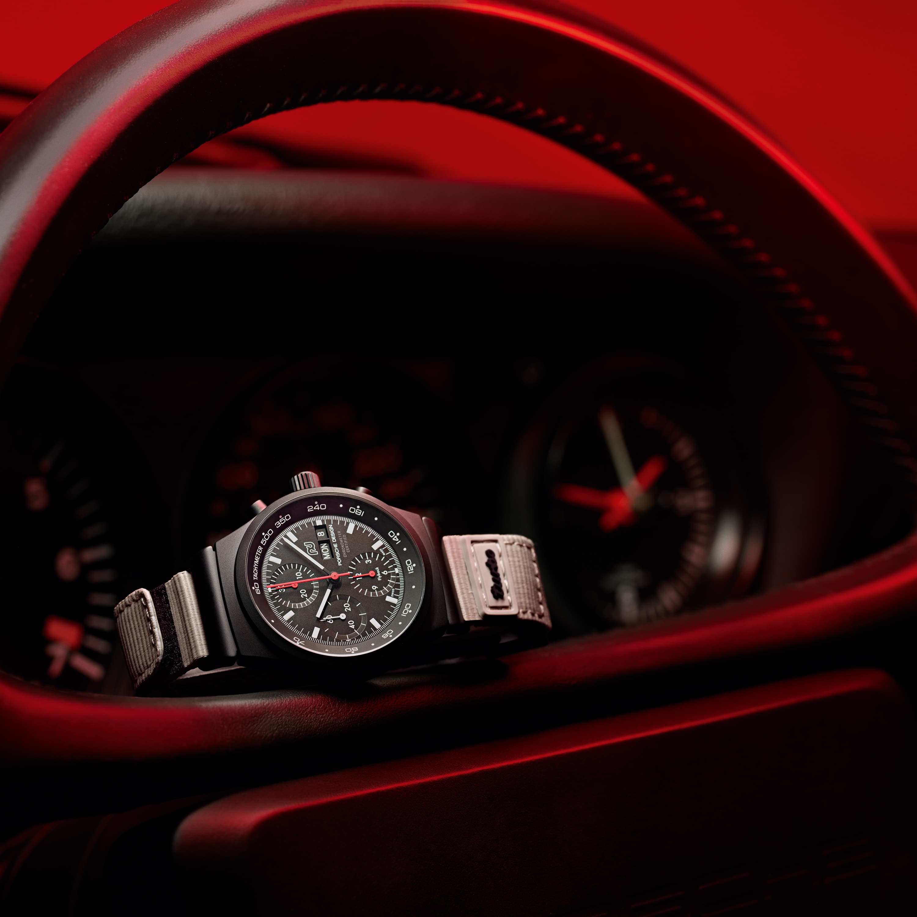 Chronograph 1 - 50 Years 911 Turbo Edition is placed on the steering wheel of the Porsche 911 Turbo