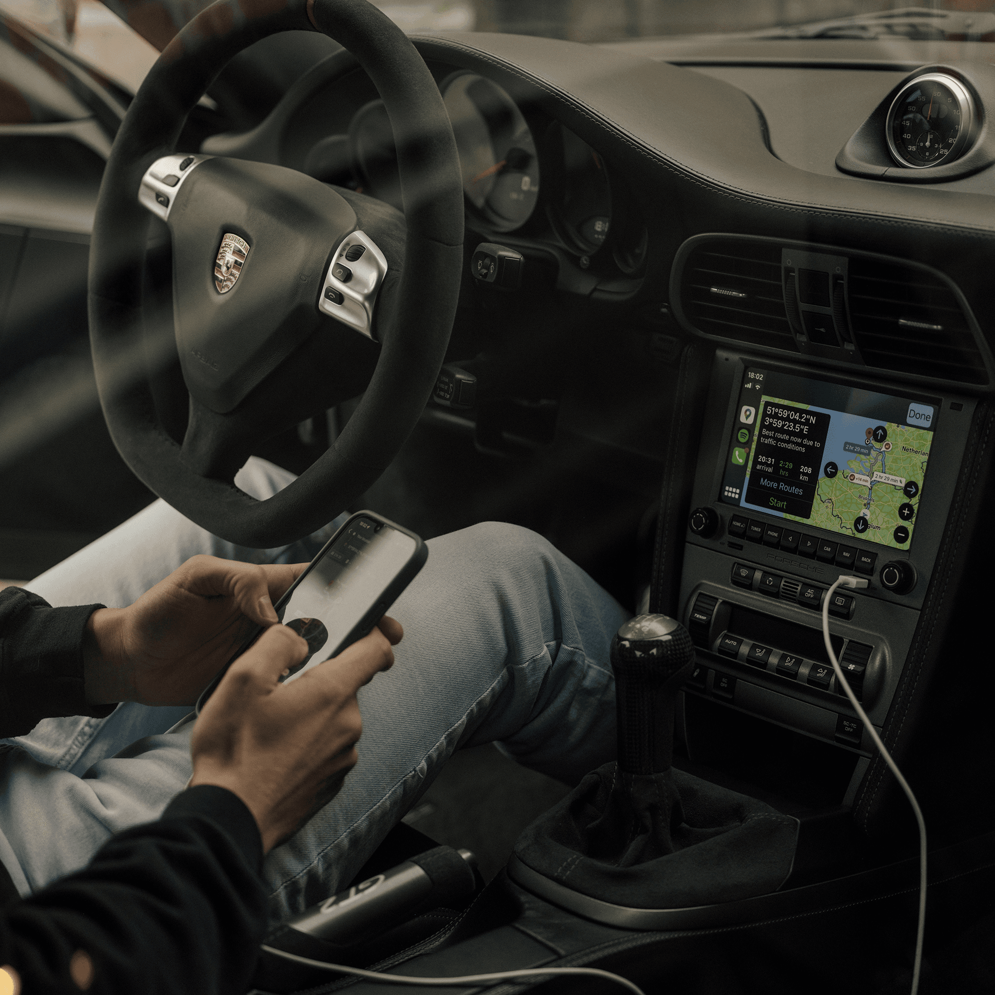 person in a car with a PCCM system and a smartphone
