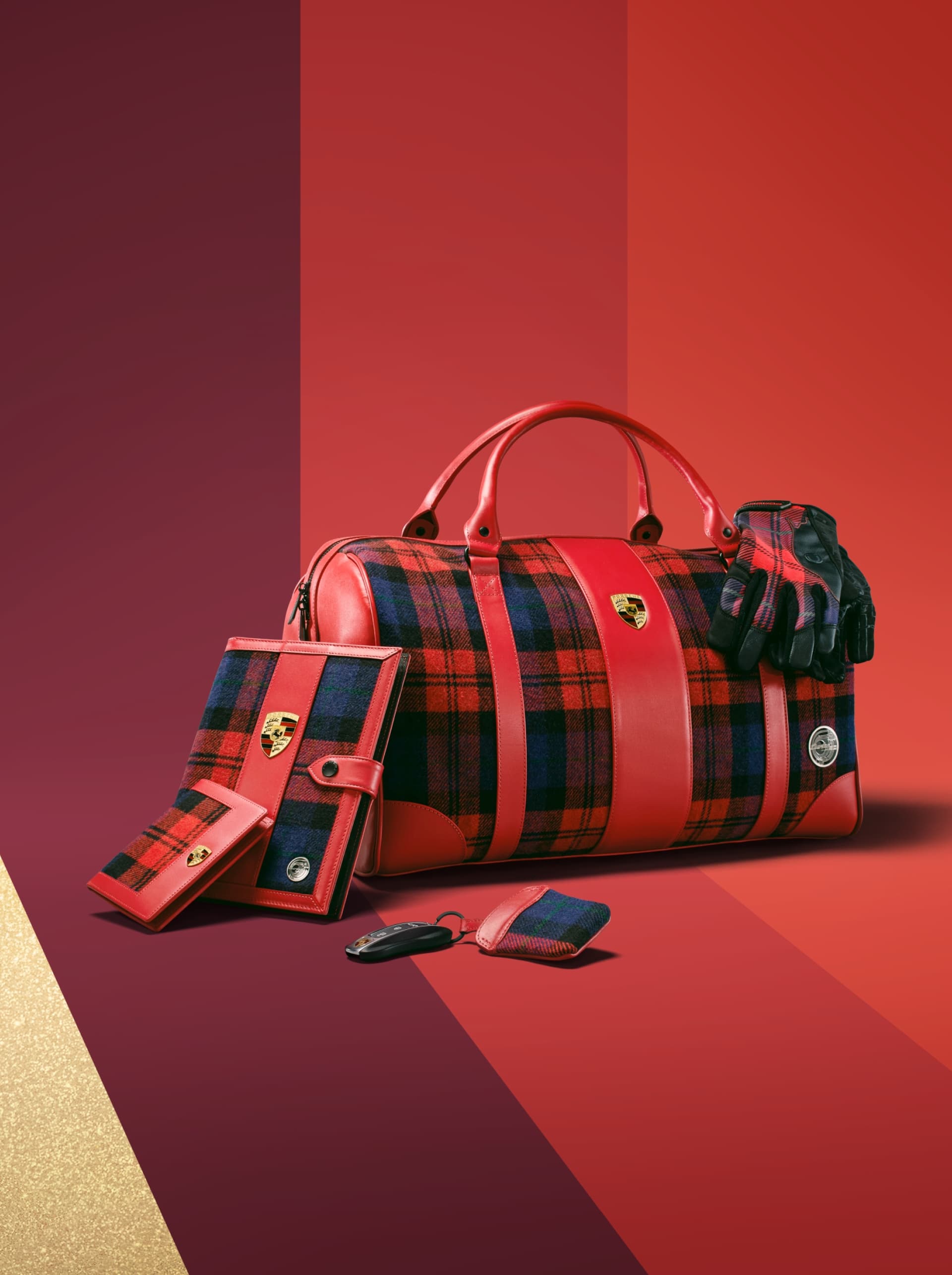 Red plaid leather bag with Porsche logo, matching gloves, wallet, and key pouch on a red gradient background.