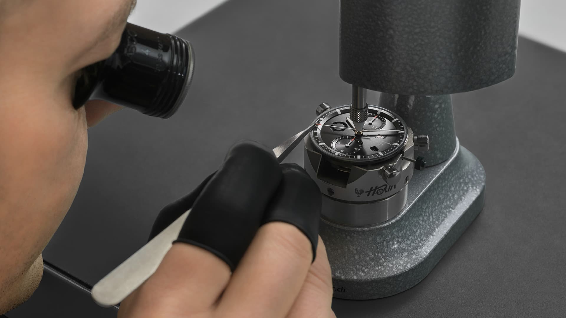 The picture shows precision work on the movement of the Chronograph 911 Sport Classic