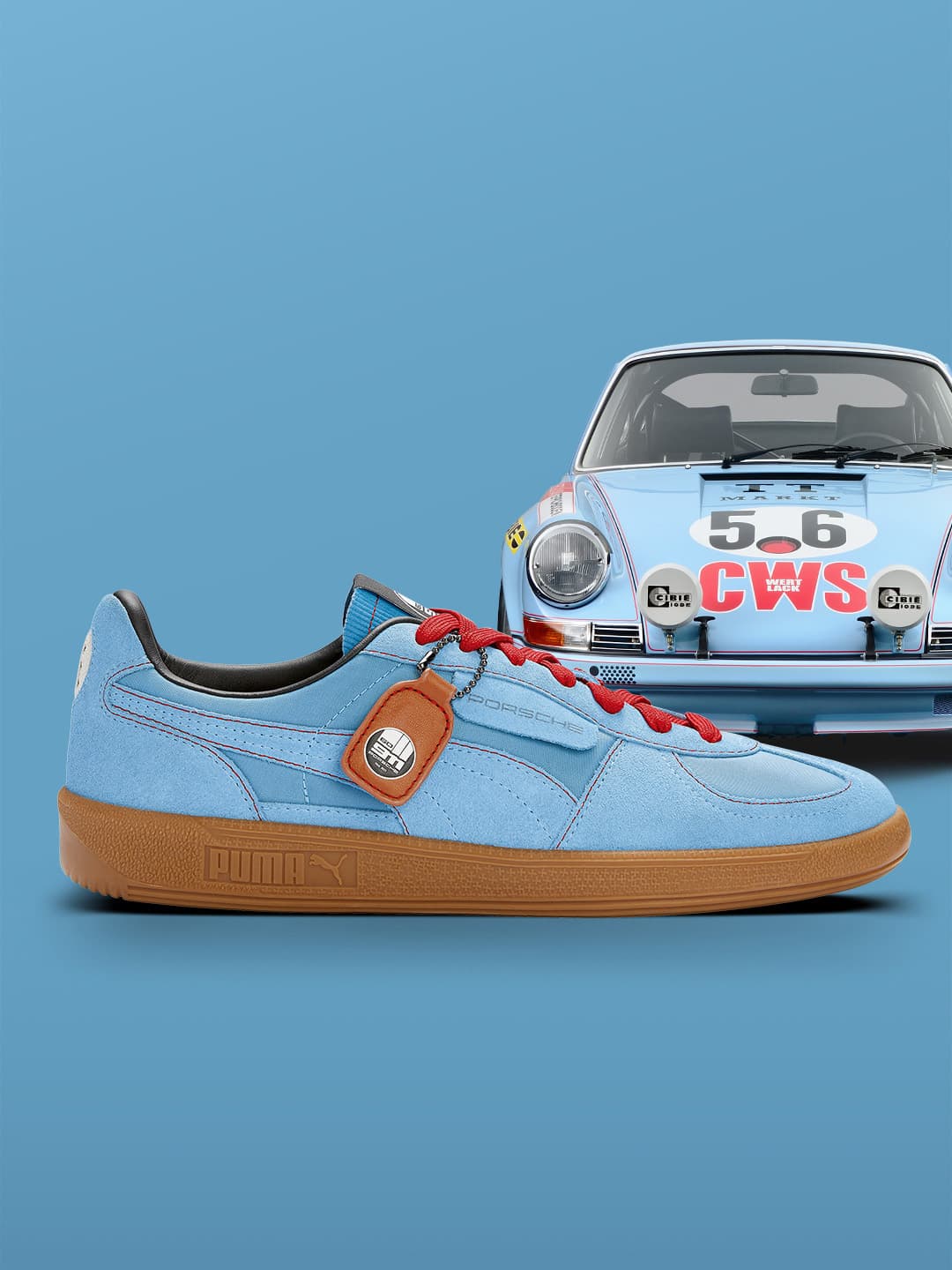 Pictured is a blue Puma sneaker on the side in cooperation with Porsche and in the background is a blue oldtimer with colourful embellishments from Porsche on the front.