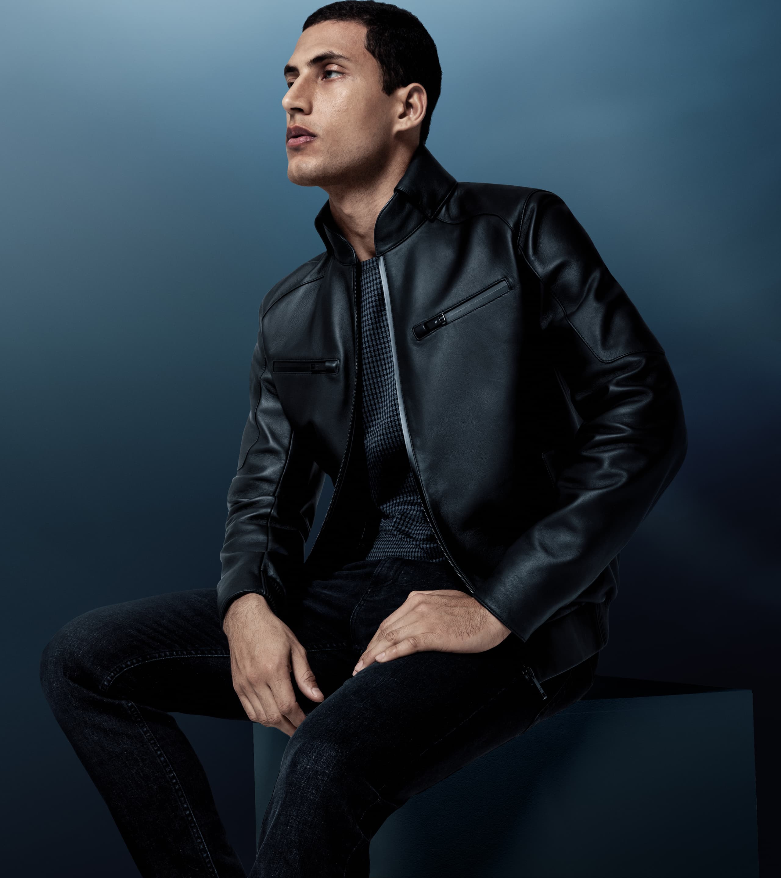 Man sitting, wearing a Porsche Design leather jacket