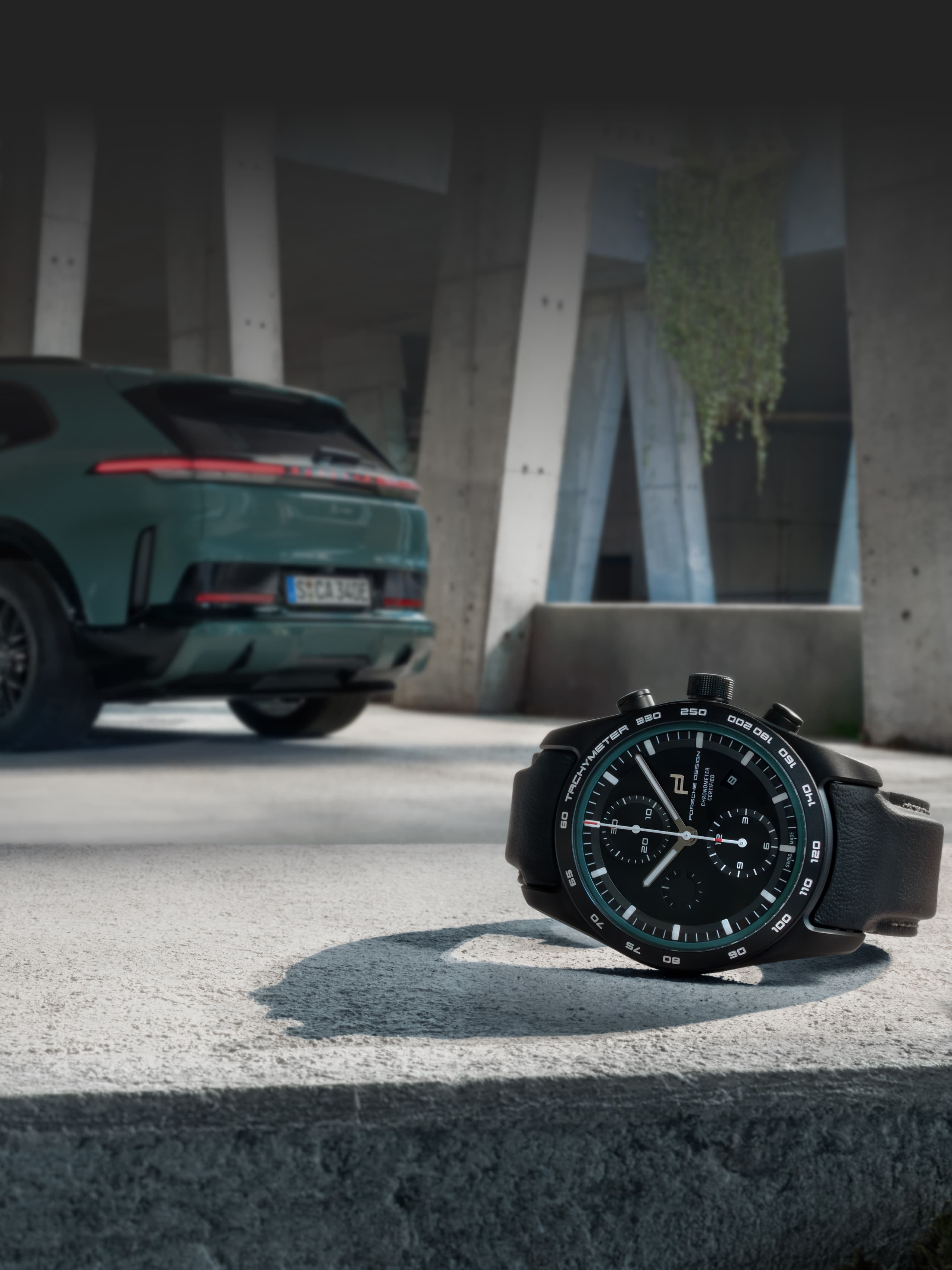 Image shows the custom-built Chronograph Cayenne Turbo Electric the front and a Porsche Cayenne Turbo Electric in the background