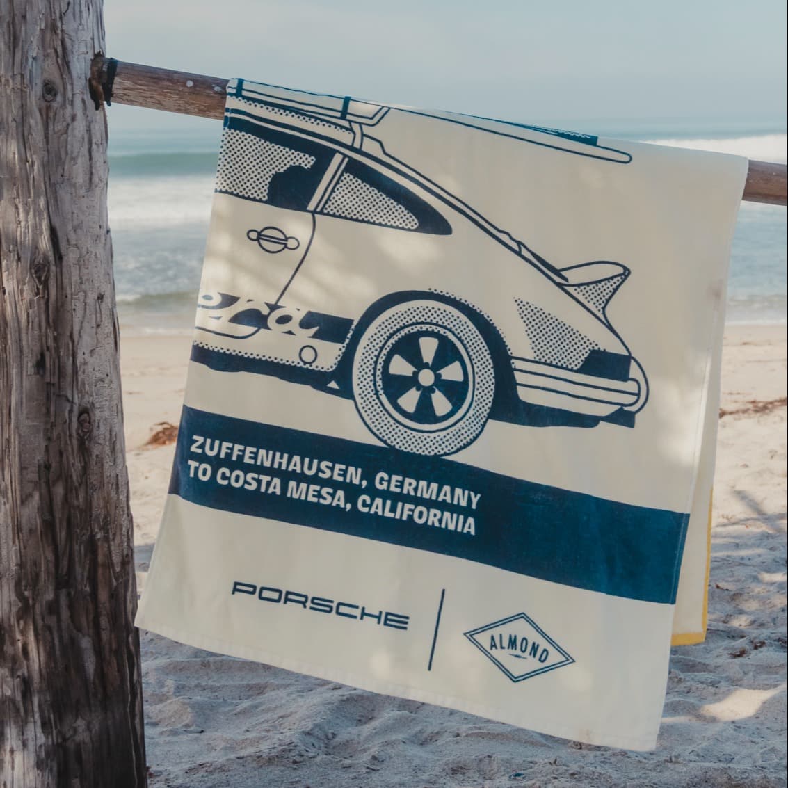 Beach towel hanging over branch on beach