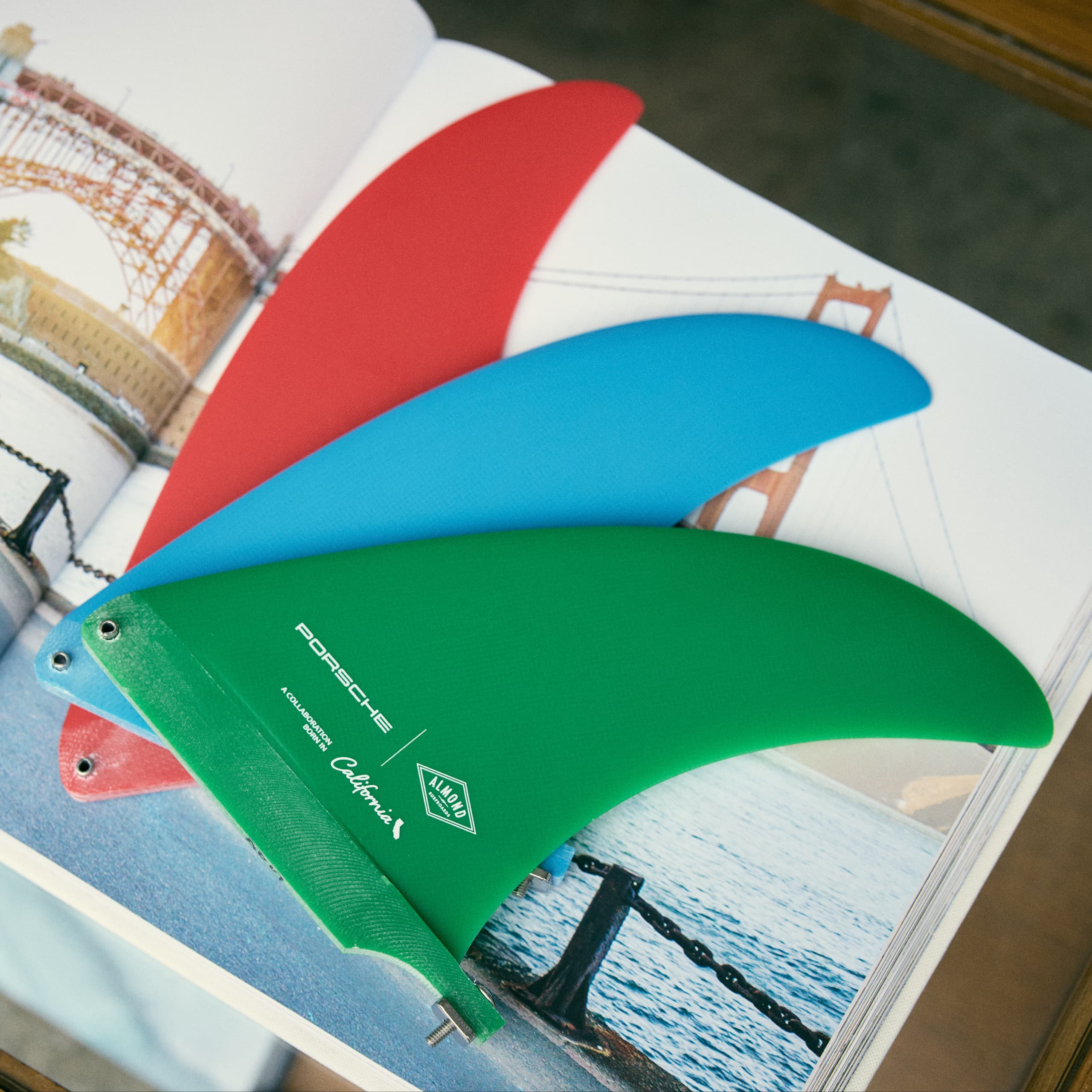 Red, Blue and Green Surfboard Fin on book