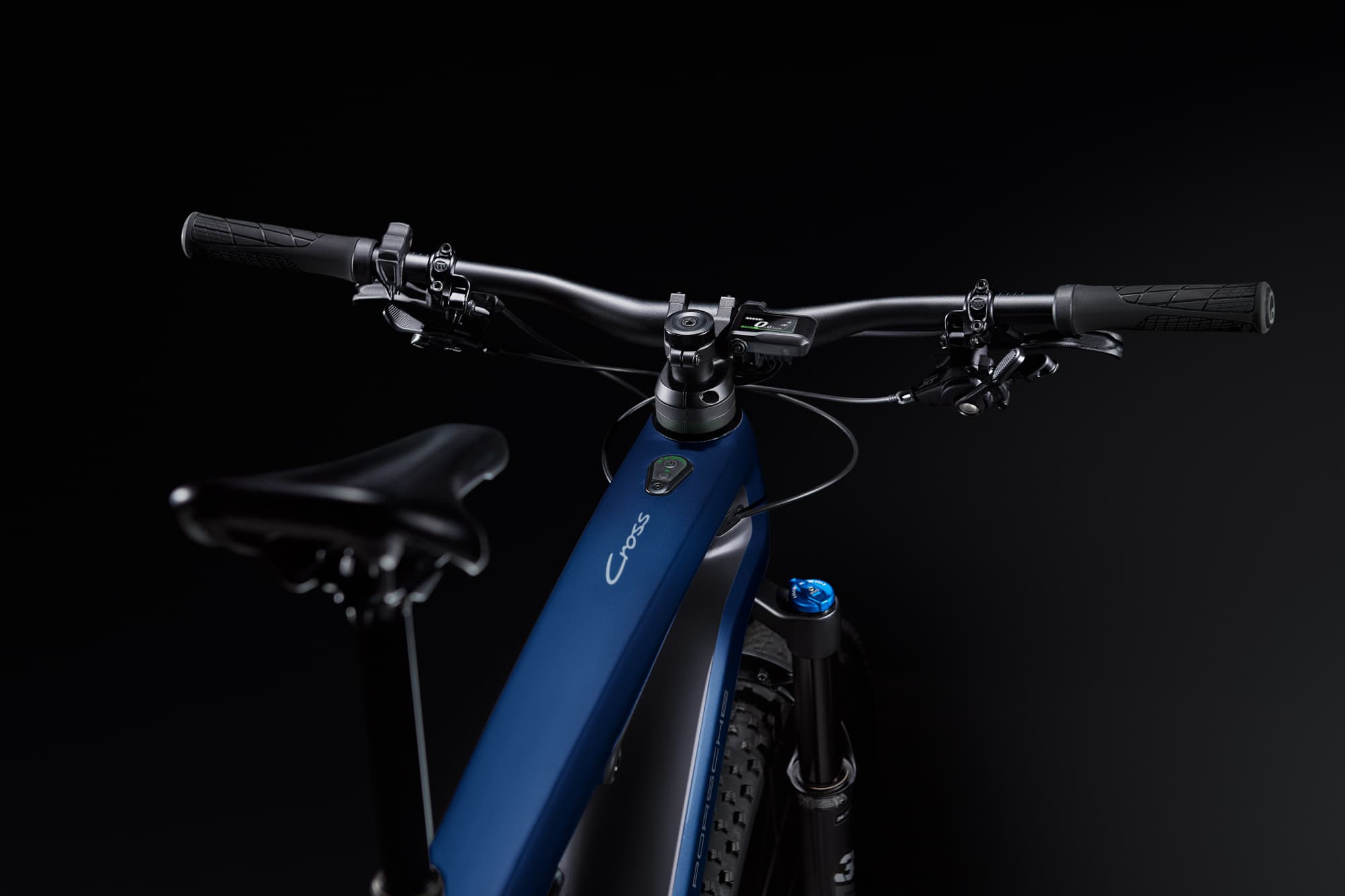 Close up of a Porsche eBike Cross in blue lying on ground