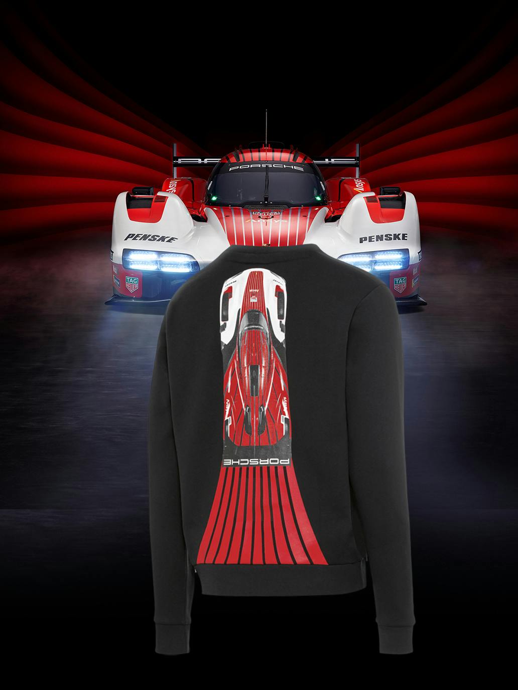 You can see a black sweater with a red racing car. In the background there is also a red race car.