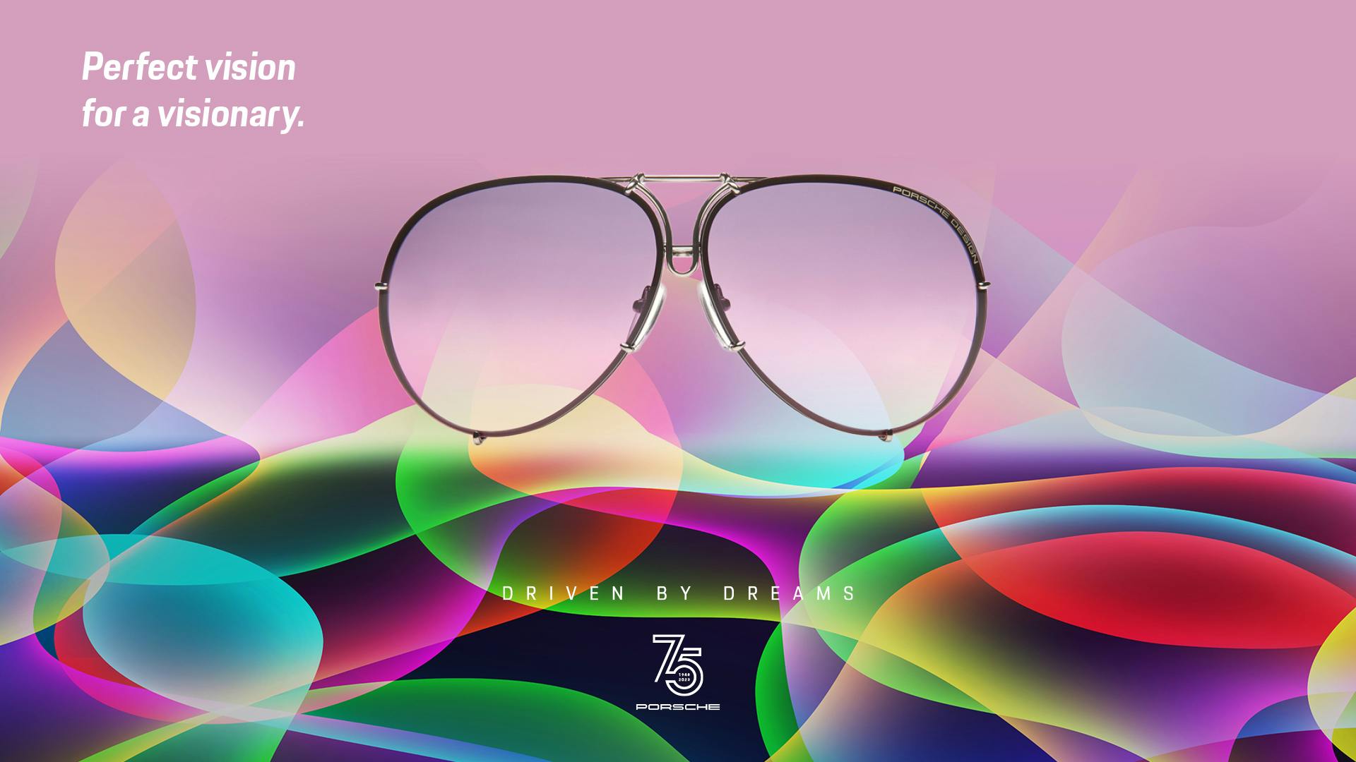 A pair of Porsche sunglasses is depicted on a colorful background. Decorated with the inscription "Perfect vision for visionary" in the top left corner. In the foreground of the picture is the white lettering "Driven by Dreams" with the number 75, which stands for 75 years of Porsche sports cars.