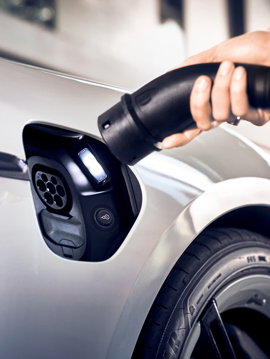 Open Taycan charging dock with person want to plug in the charger