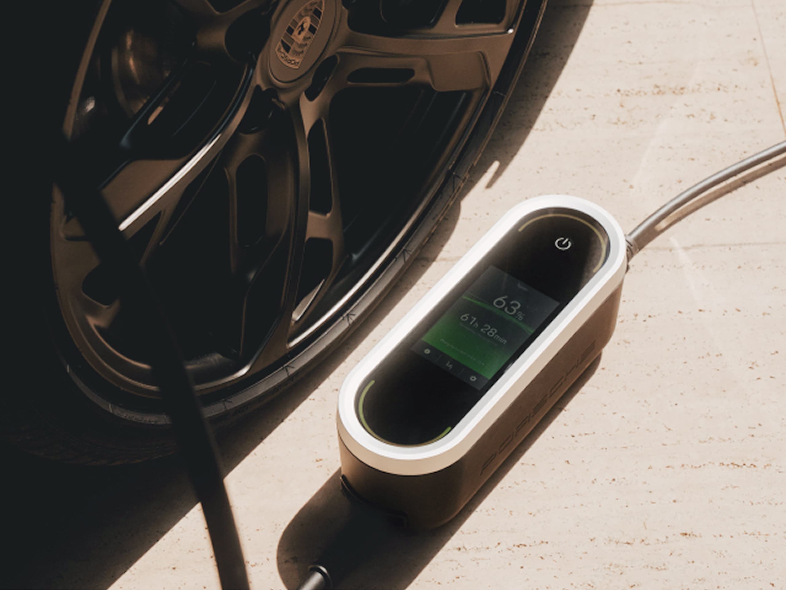 You can see a Porsche Mobile Charger Connect lying on the ground