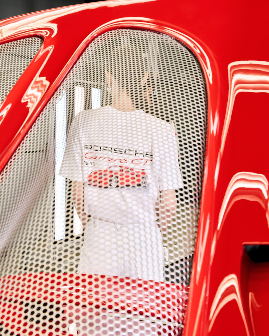 Woman wearing a T-shirt from the Porsche Carrera GT 25th Anniversary Collection