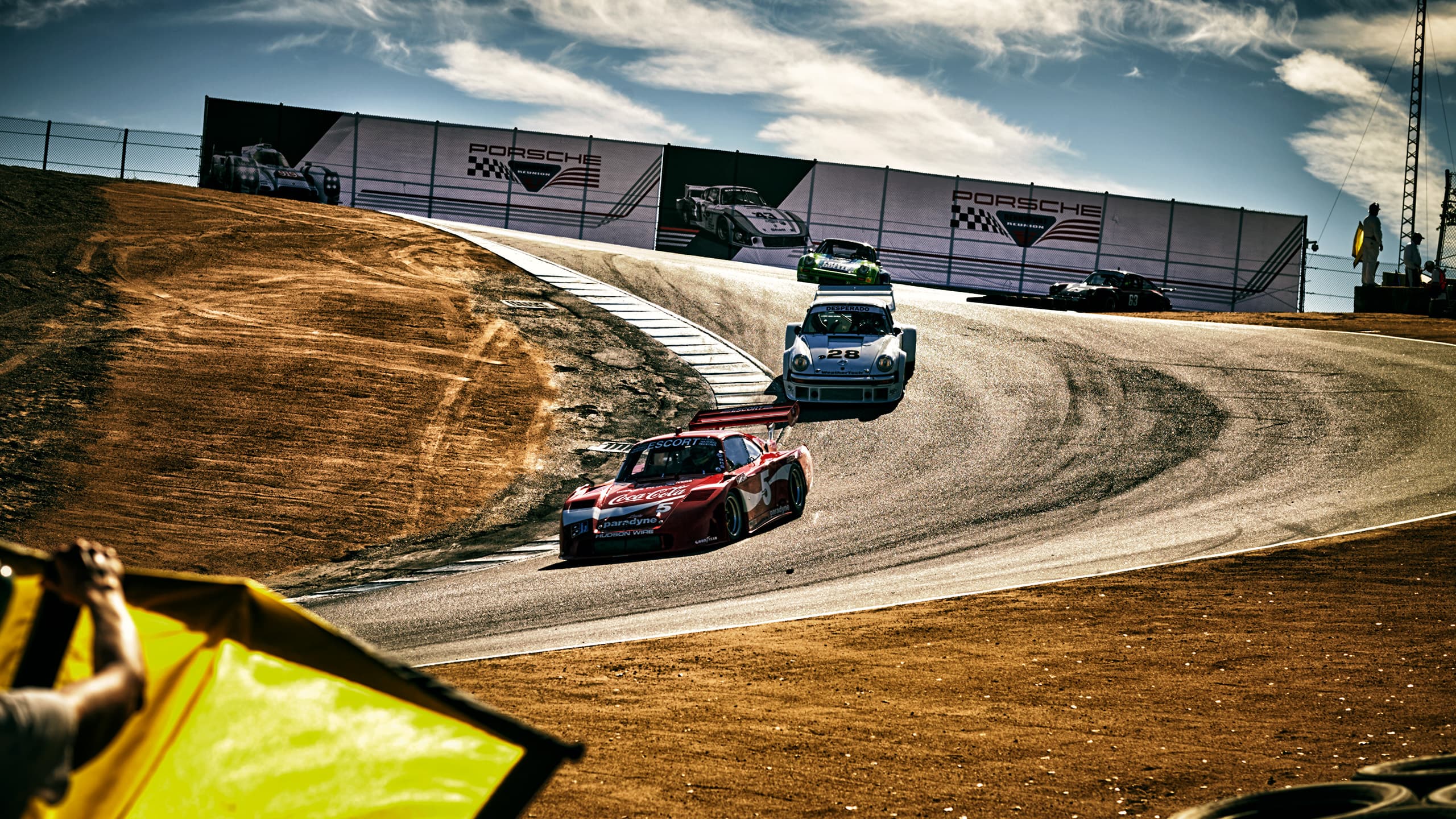 On display is a Porsche race track as part of the Porsche Rennsport Reunion 7 on which several older vehicles from Porsche are racing