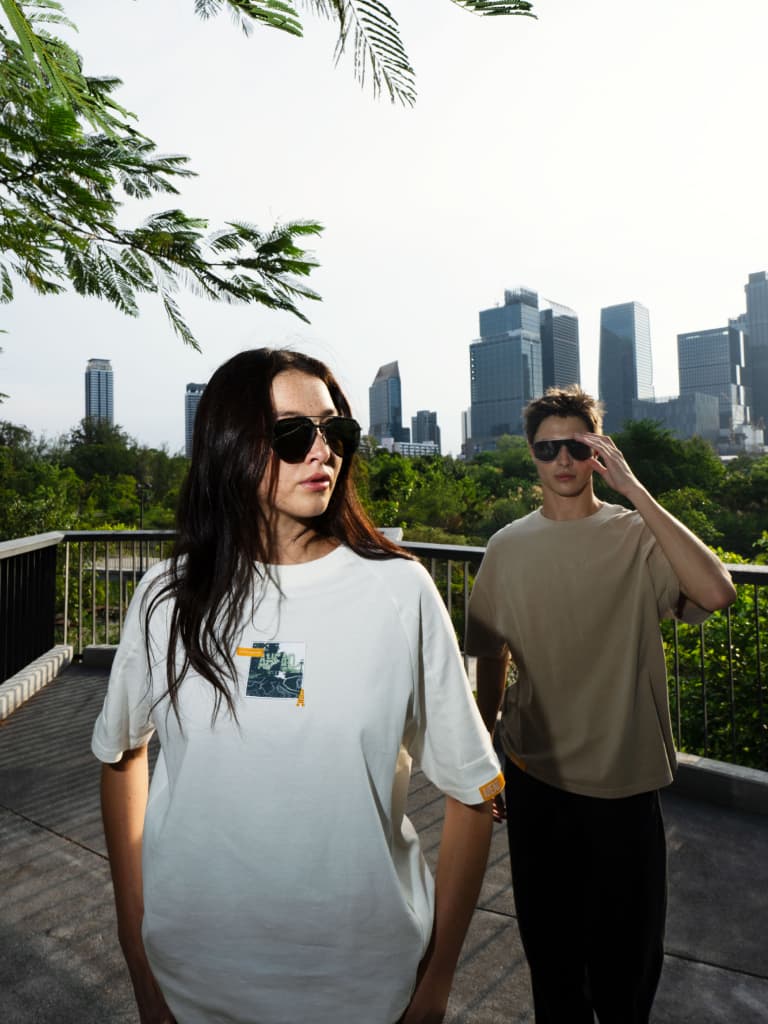 Man and woman wearing ta white and a brown Tshirt of the Porsche Ahead Collection