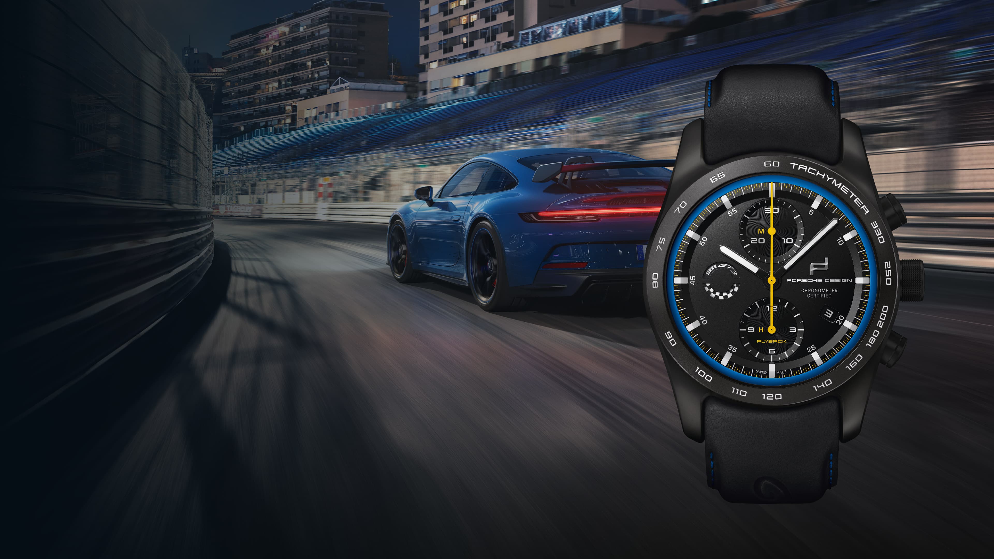 Pictured is the Chronograph 911 GT3 Porsche wristwatch and in the background is a blue Porsche GT3 on the road