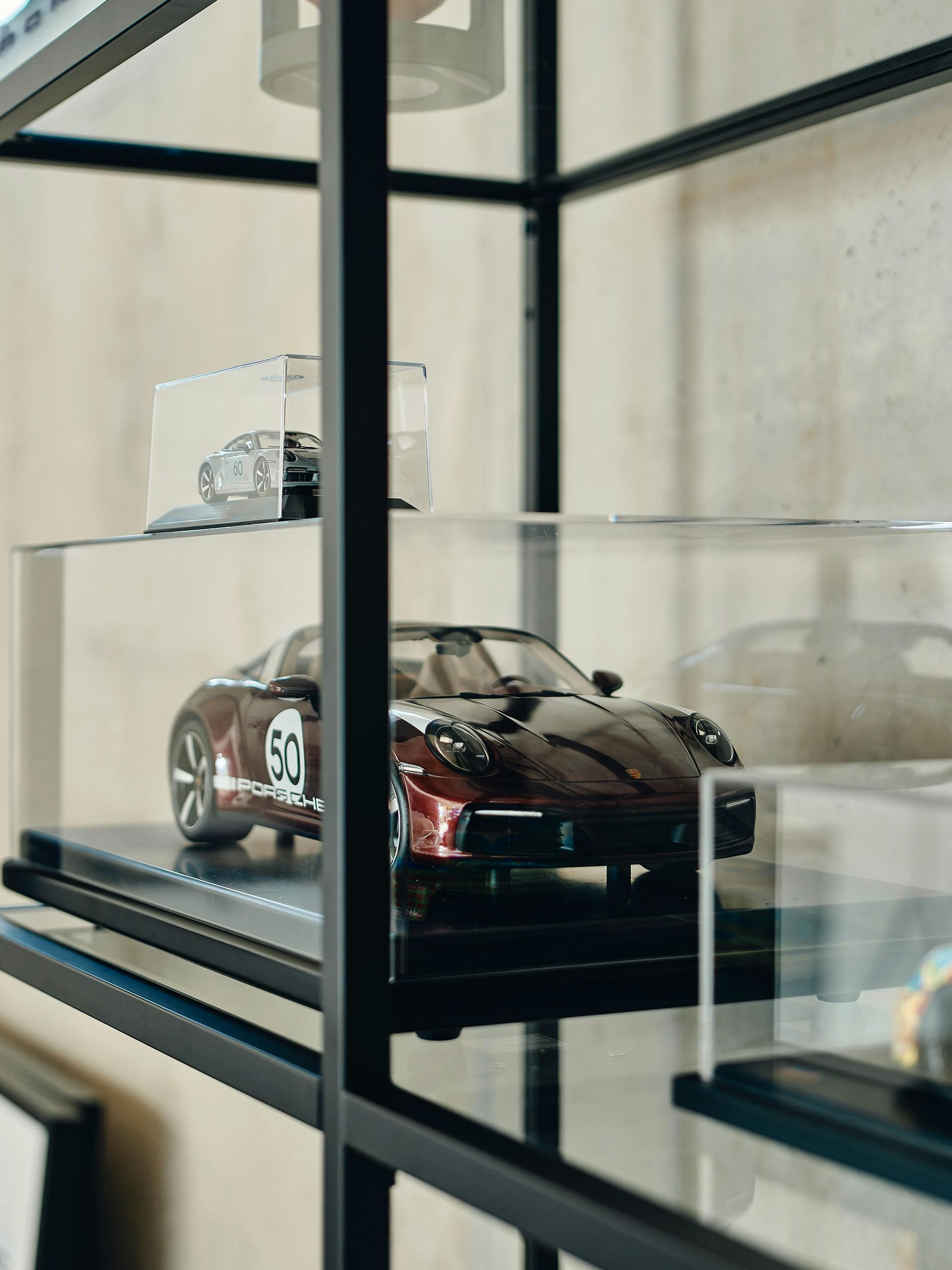 Shown are model cars from Porsche in a glass cabinet