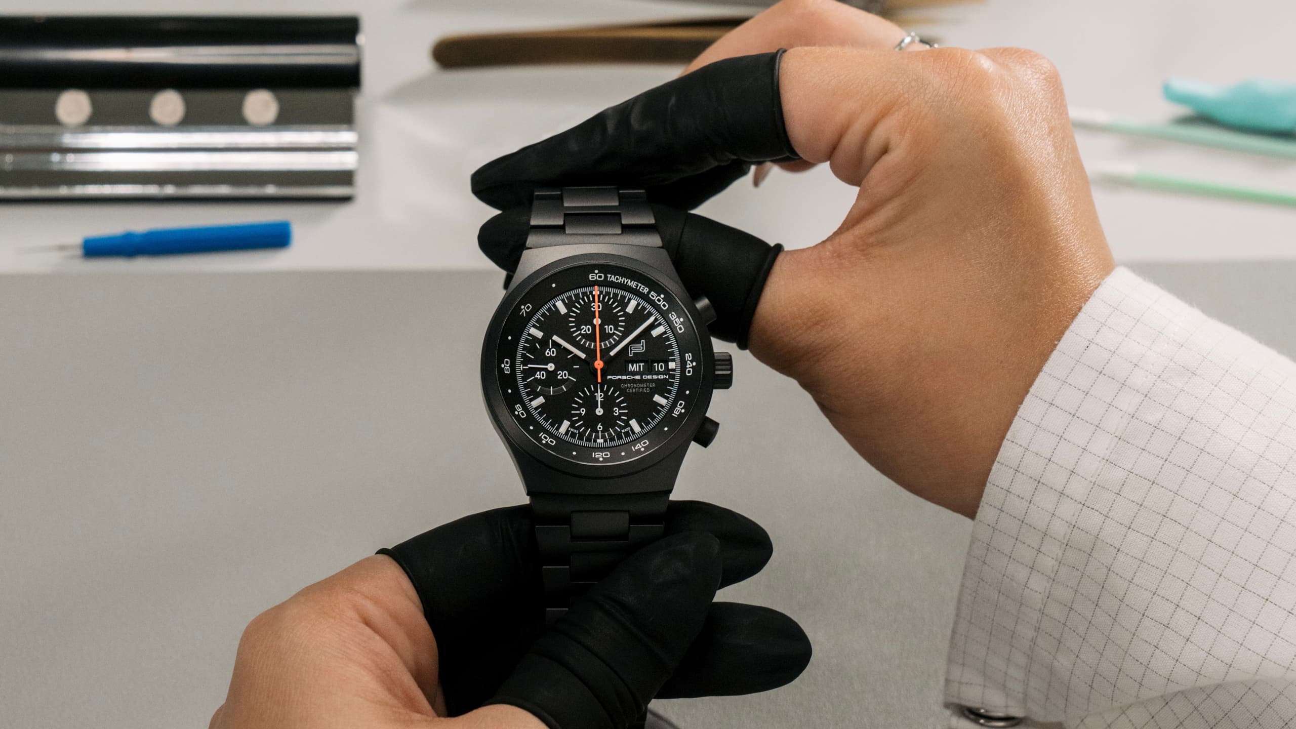 watchmaker holding the porsche design chronograph 1 all black