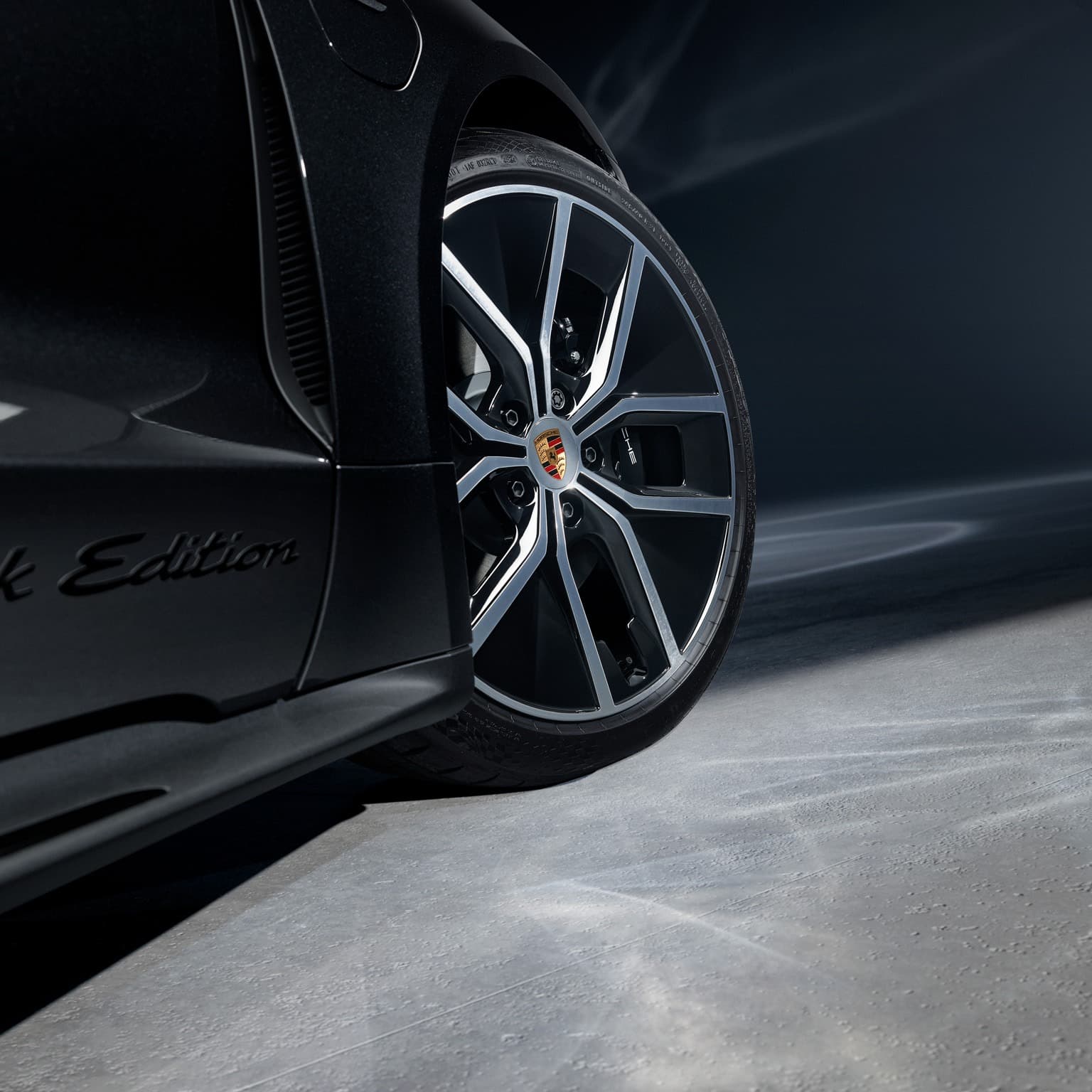 You can see a close up of a Porsche rim and wheel