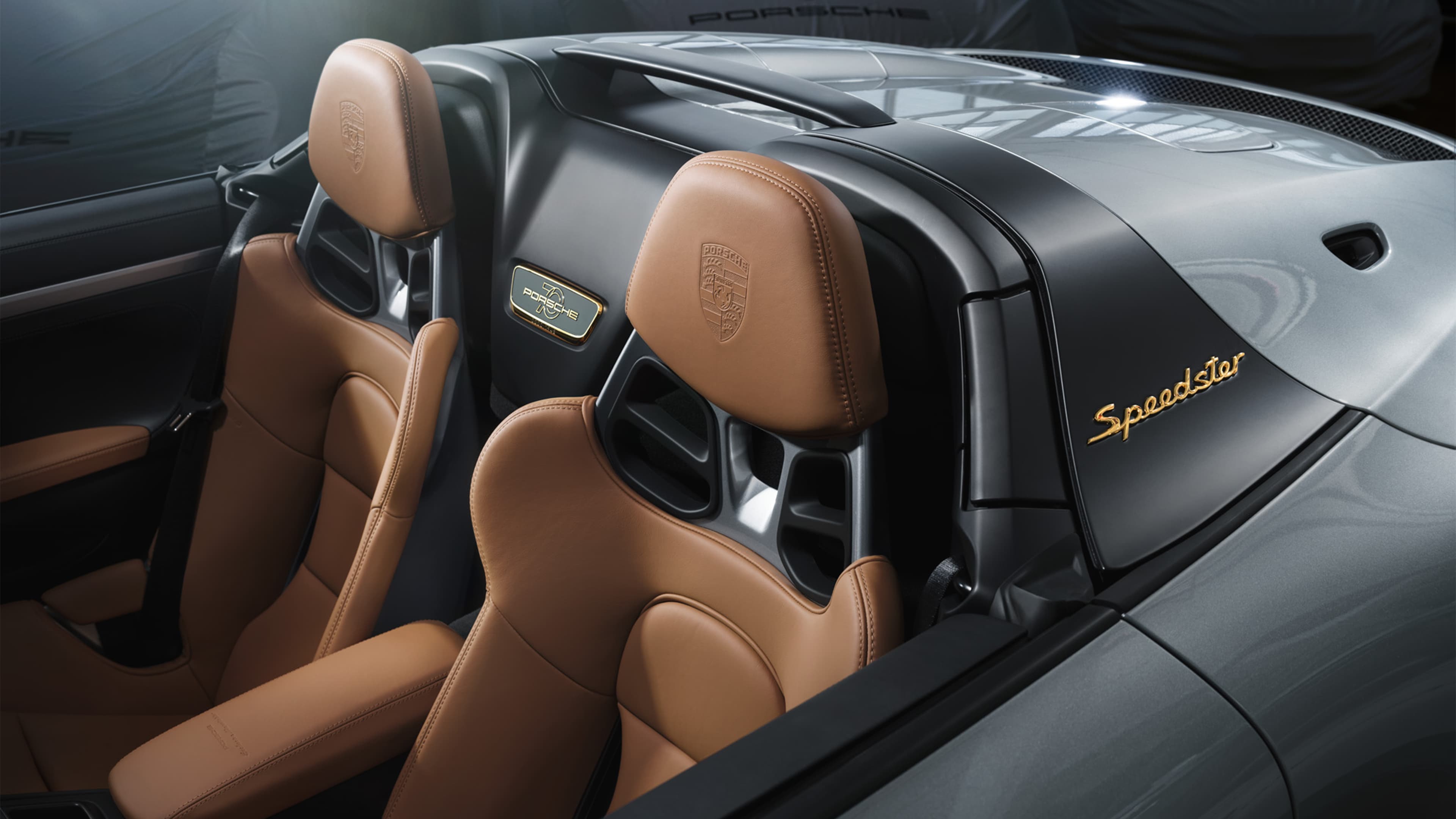 Pictured is a Porsche 911 Speedster with brown leather seats