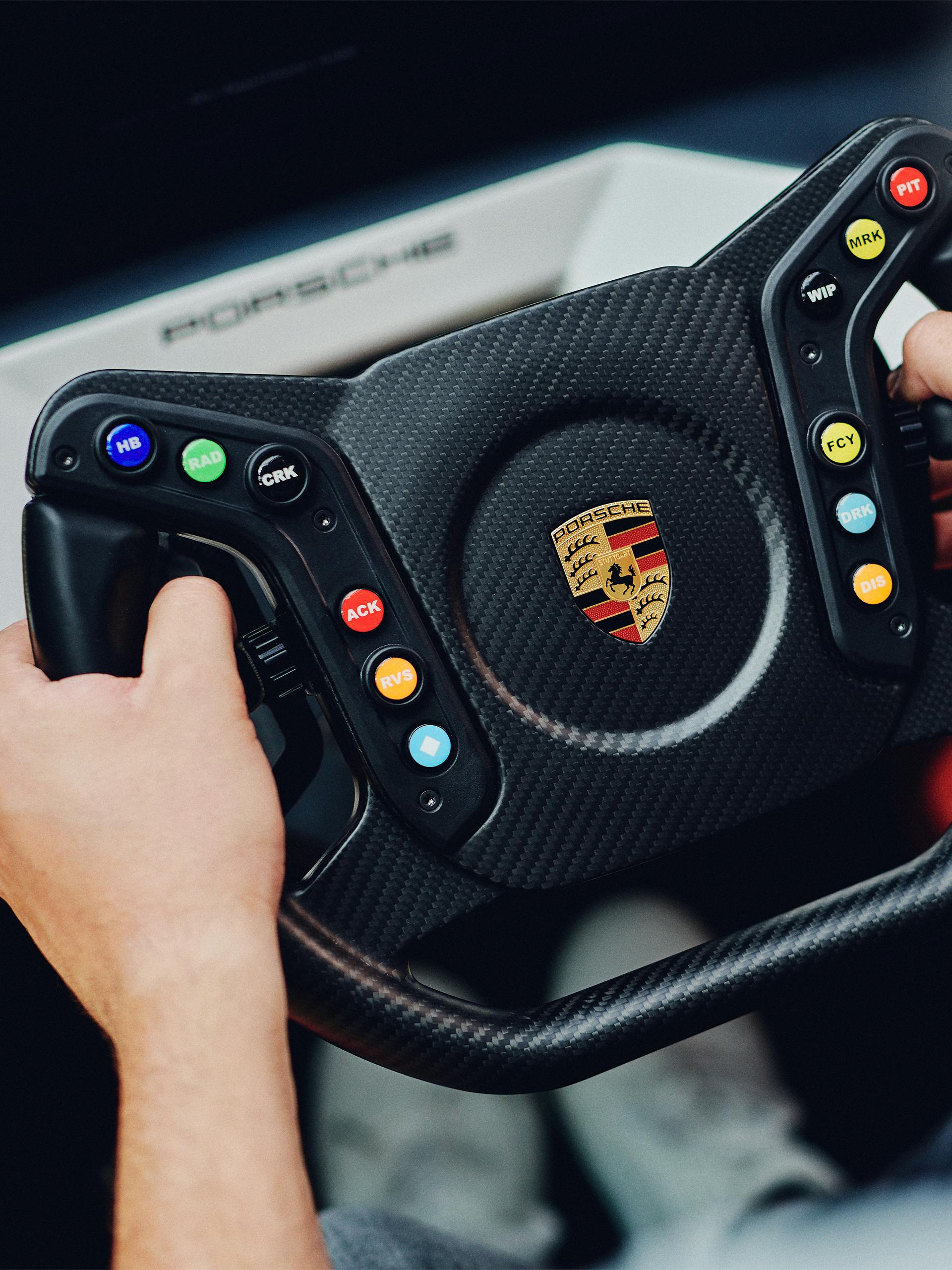 Frontal pictured is the new Porsche Gaming steering wheel in black color as it is currently in use.