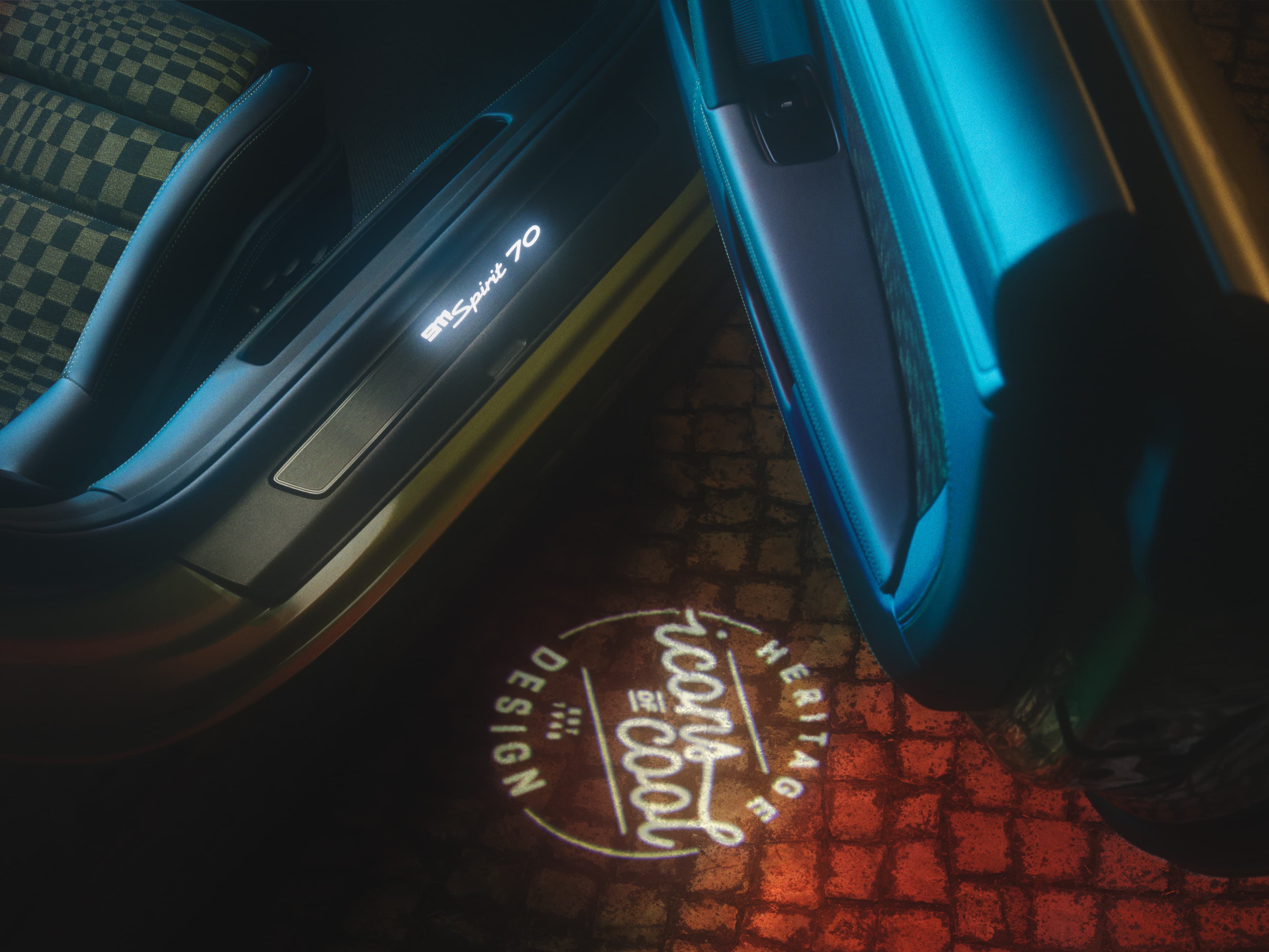 Opened passenger door of the Porsche 911 Spirit 70 with Icon of Cool light projection on the floor