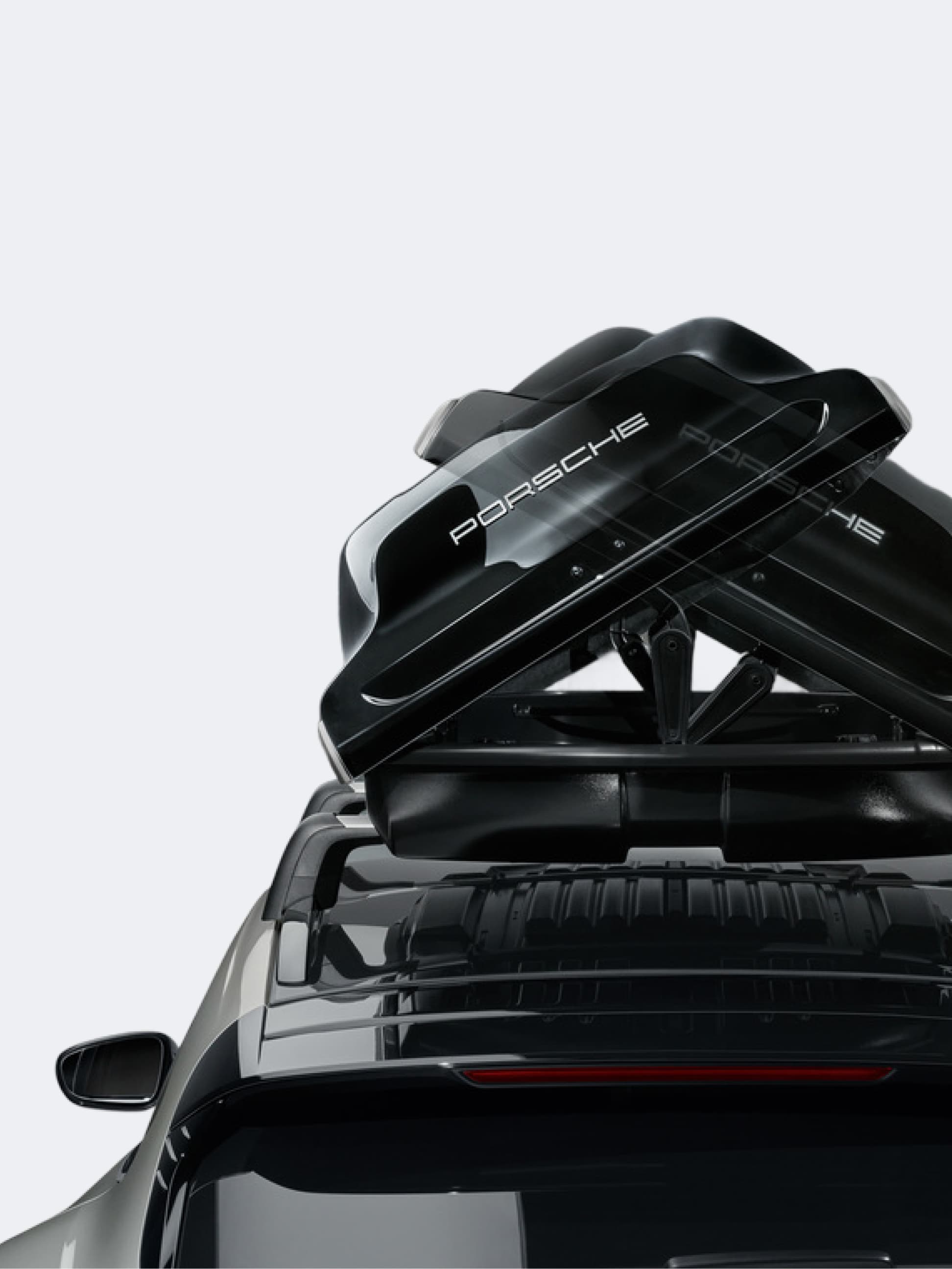 You can see a close up of a Porsche roof box on a car