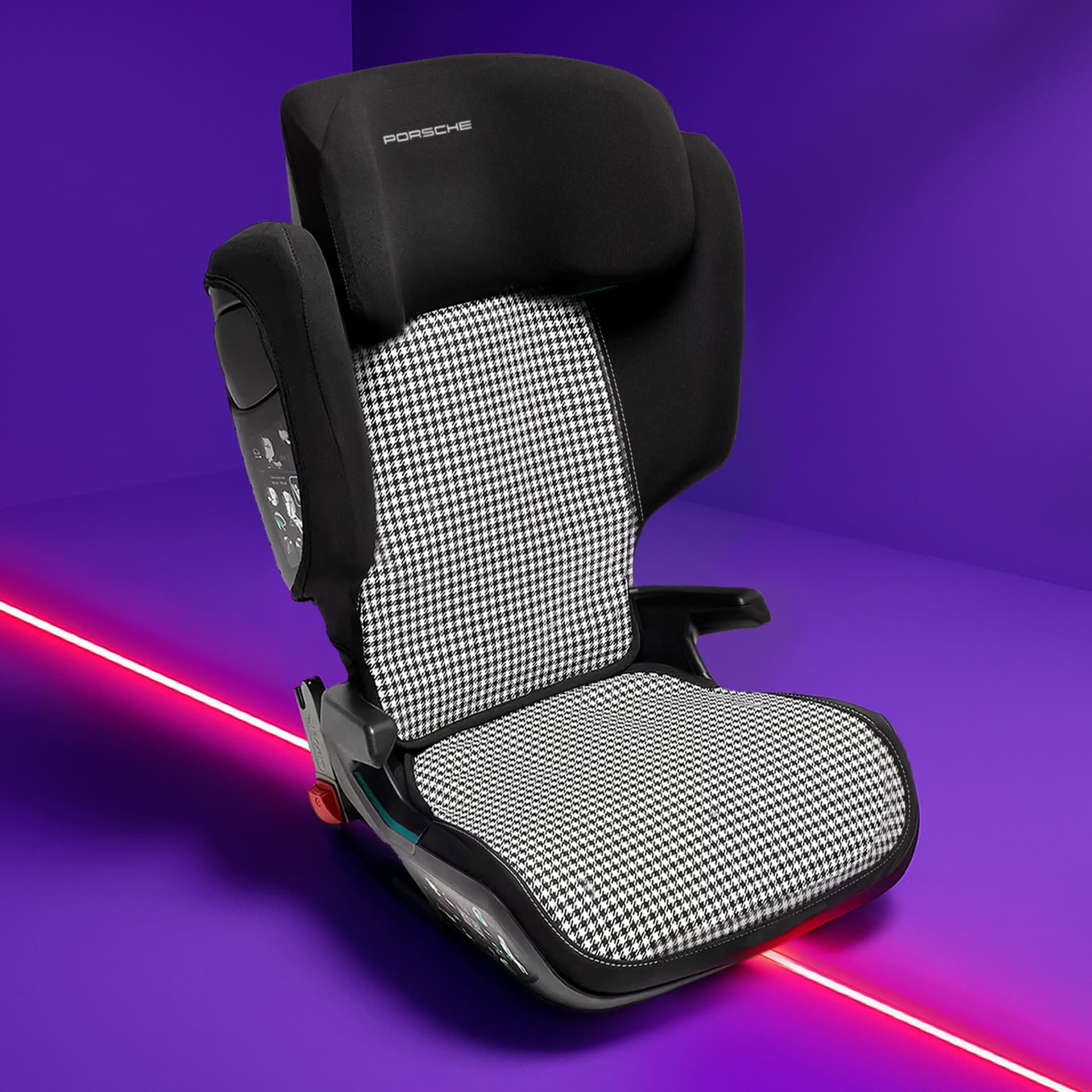 Black and white houndstooth Porsche child seat on a vibrant purple background with a red diagonal line.