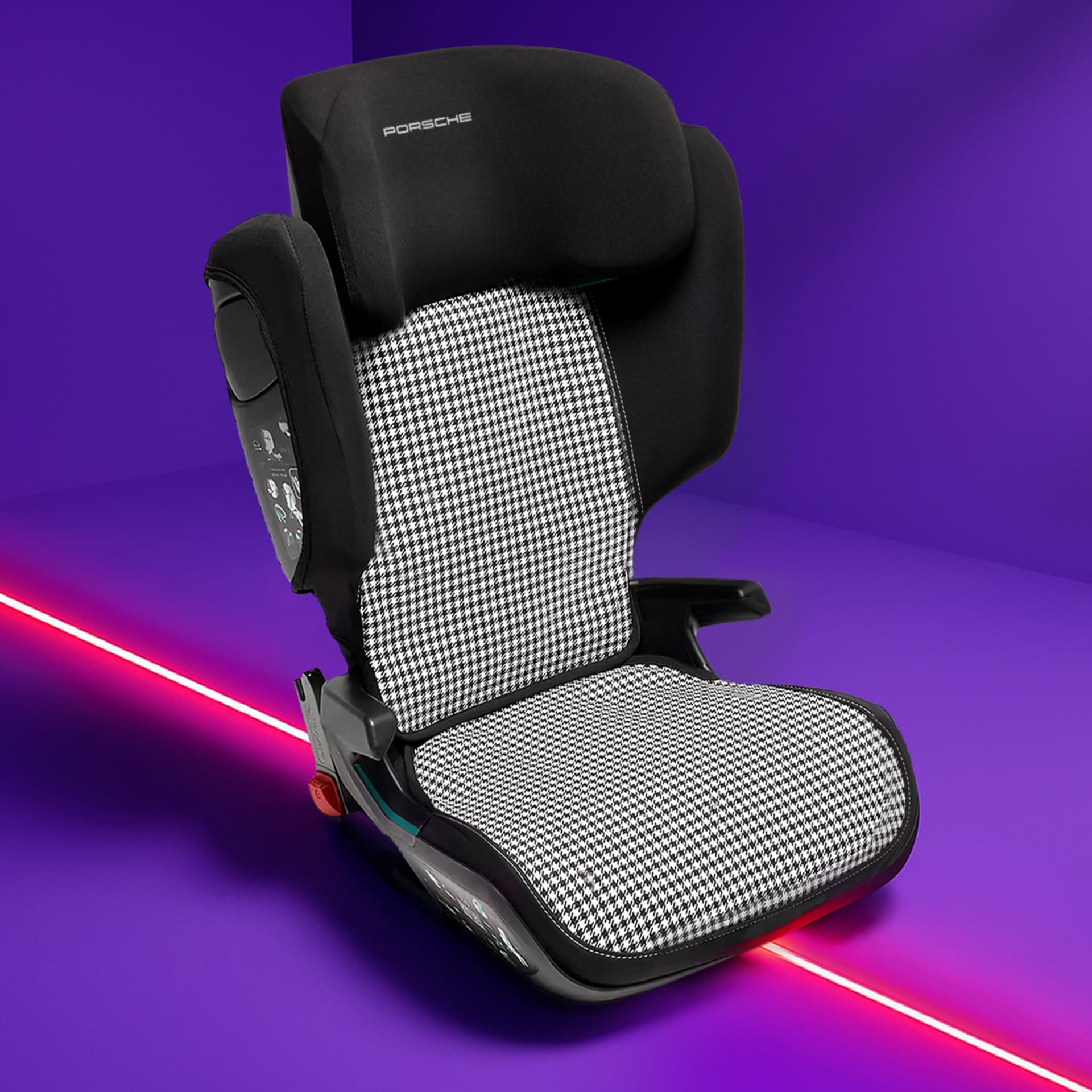 Black and white houndstooth Porsche child seat on a vibrant purple background with a red diagonal line.
