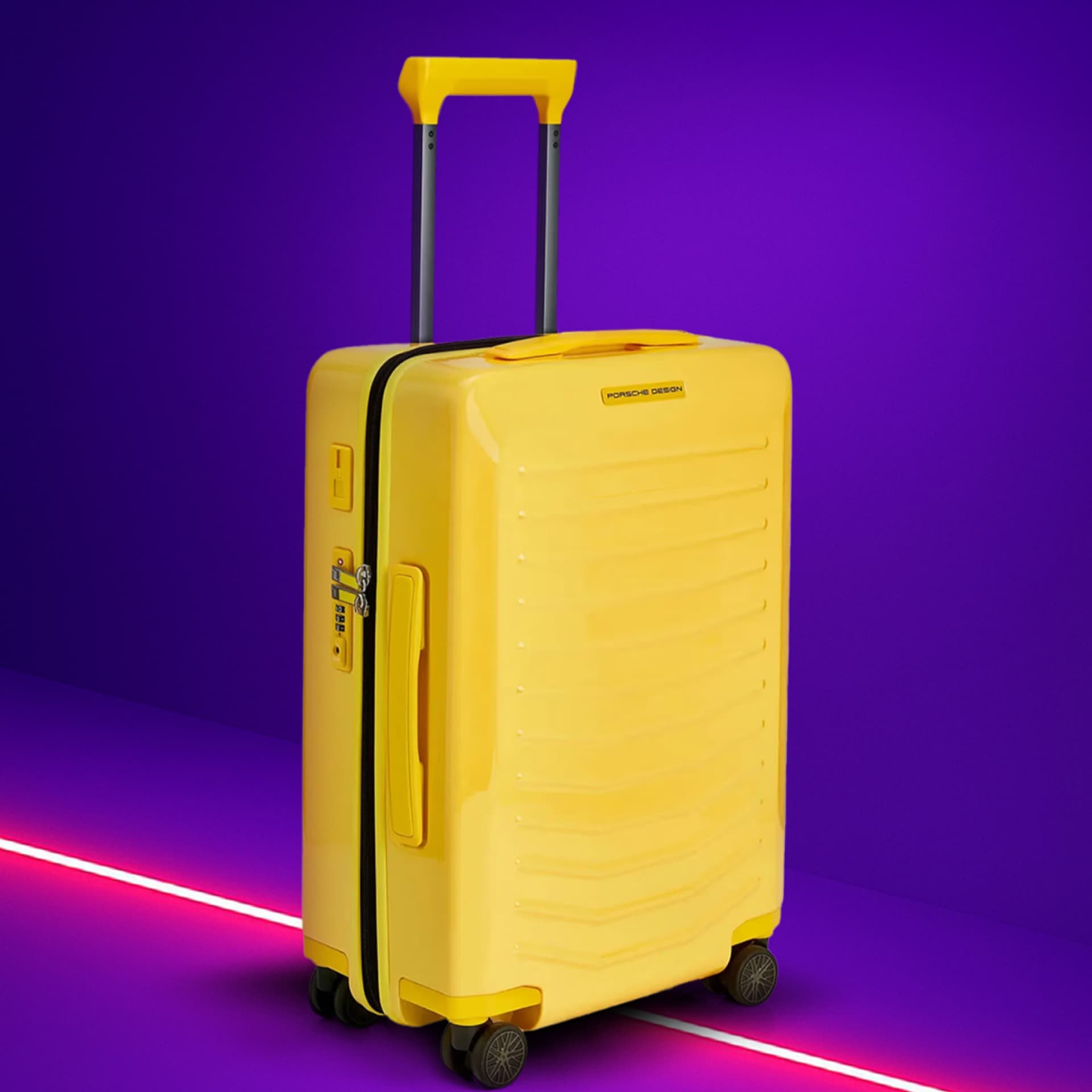 Yellow suitcase with telescopic handle on purple background, featuring Porsche Design logo and four wheels.