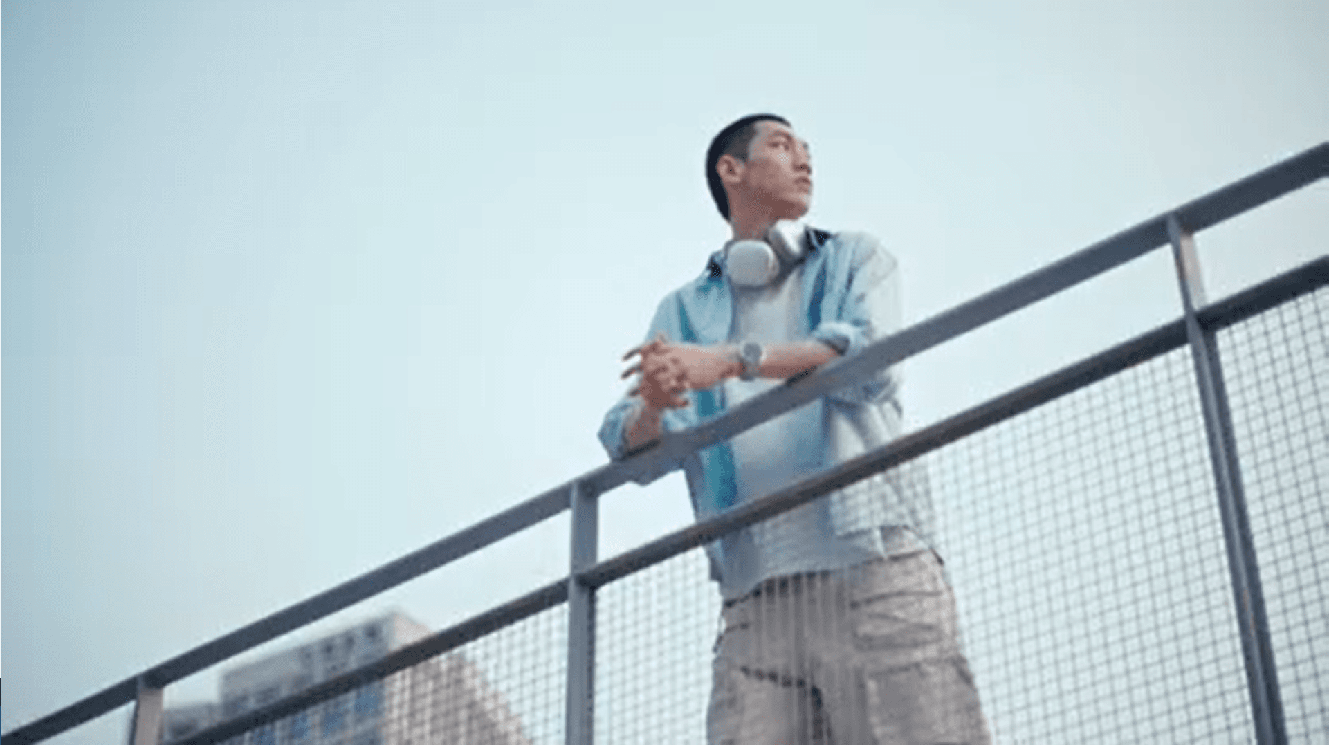 Man is standing on a bridge