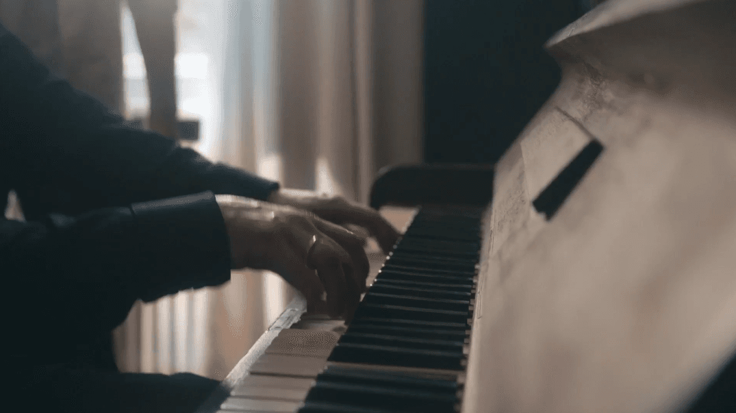 A person is playing a piano