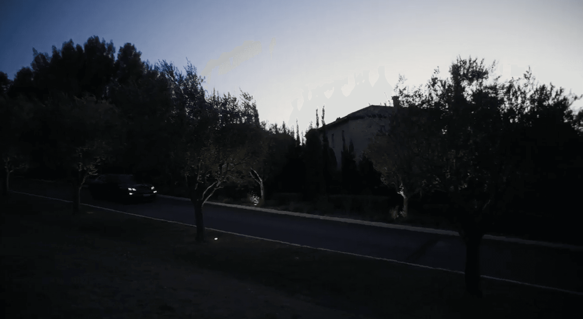 You can see a car on a road during sunrise